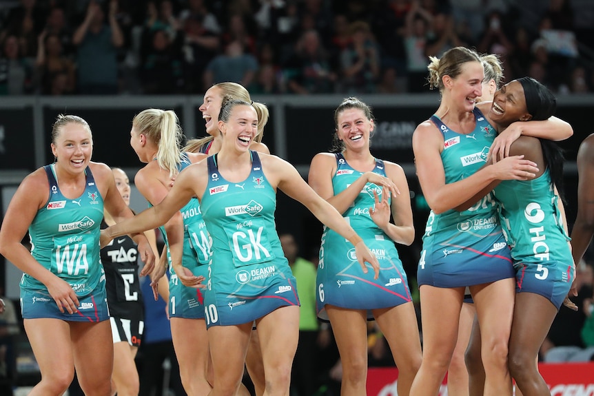 Melbourne Vixen players smile and hug