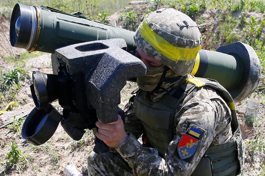A soldier holds a Javelin missile system during a military exercise.