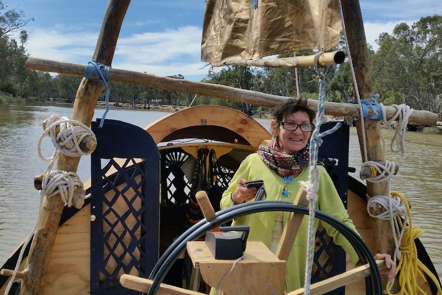 Lady steering boat on Murray River