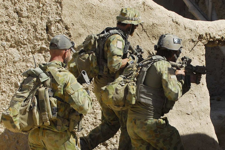 Australian special forces soldiers clear a compound