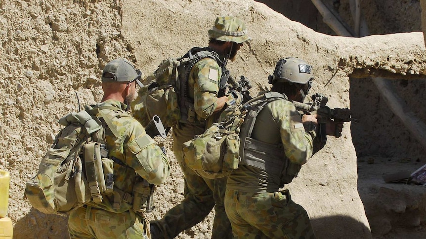 Australian special forces soldiers clear a compound
