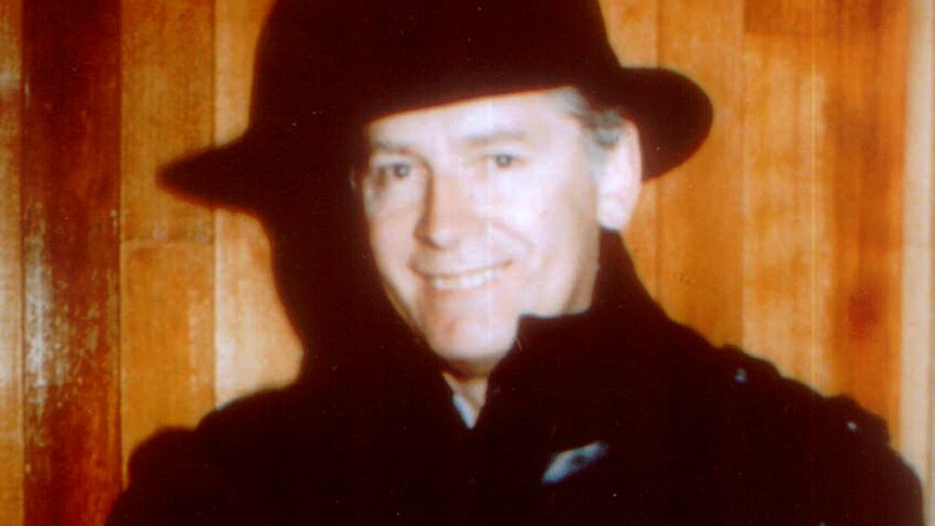 James 'Whitey' Bulger with hat and leather trench coat, smiles in an undated photo.
