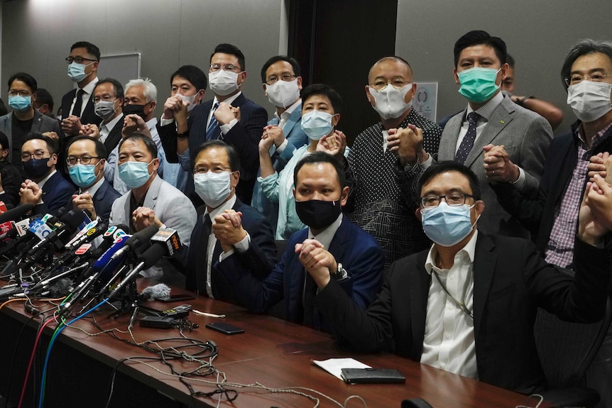 Hong Kong's pro-democracy legislators hold hands as they pose for a photo.