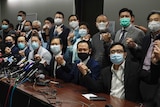 Hong Kong's pro-democracy legislators hold hands as they pose for a photo.