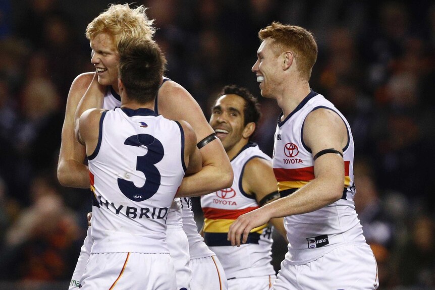 Adelaide Crows players celebrate an Elliott Himmelberg (L) goal against Carlton at Docklands.