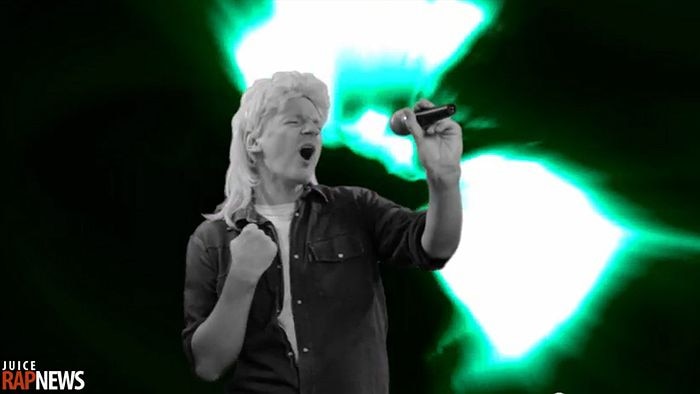 Julian Assange features in the video wearing a wig and singing a parody of John Farnham's You're The Voice.