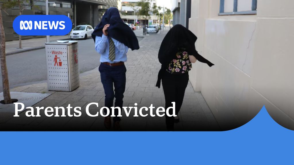 Parents Convicted: A man and a woman cover their faces with jackets as they walk along a footpath in an urban area.