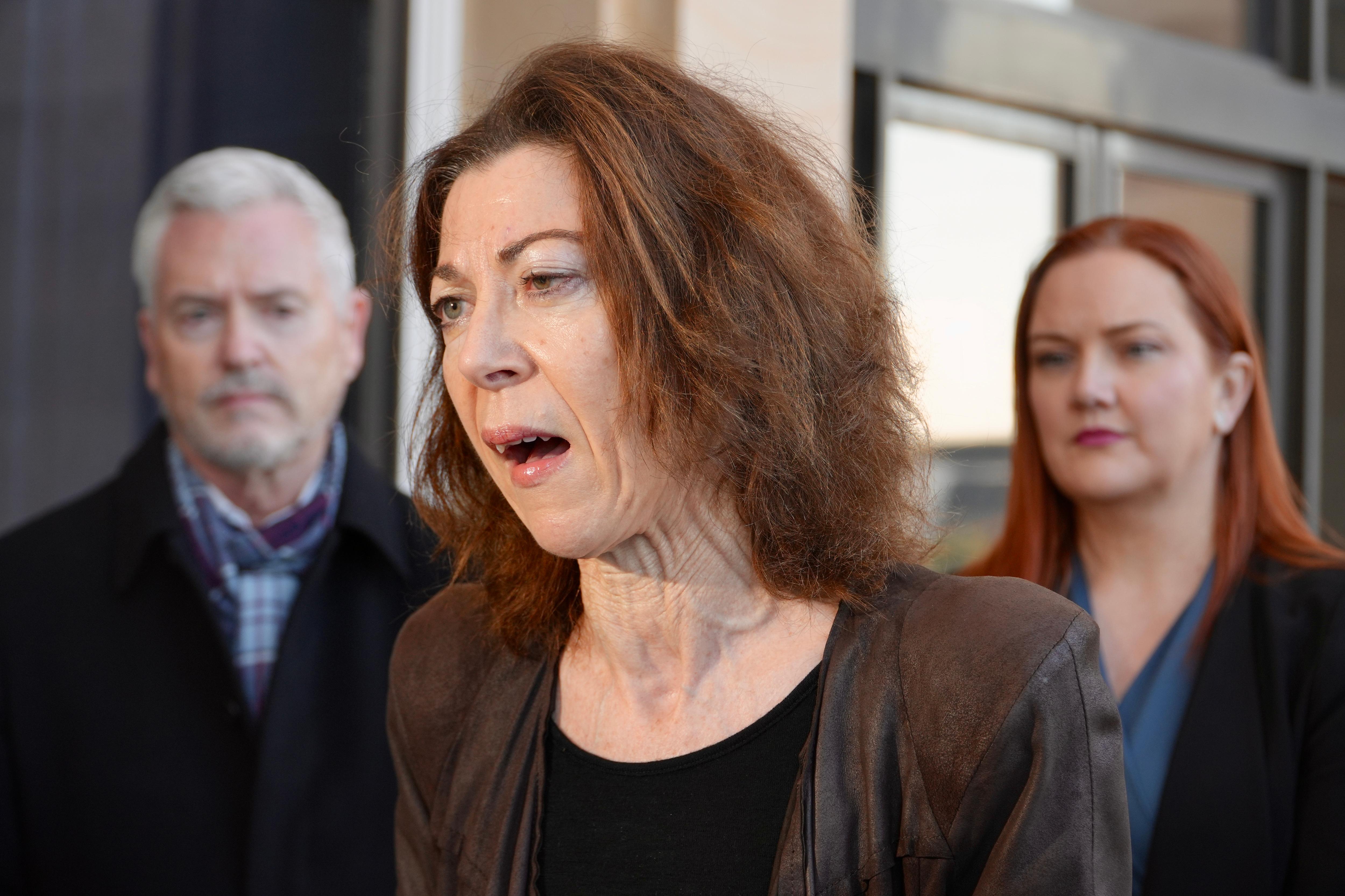 Centre for Women’s Safety and Wellbeing CEO Dr Alison Evans speaking in front of a man and woman outside WA's Parliament House.