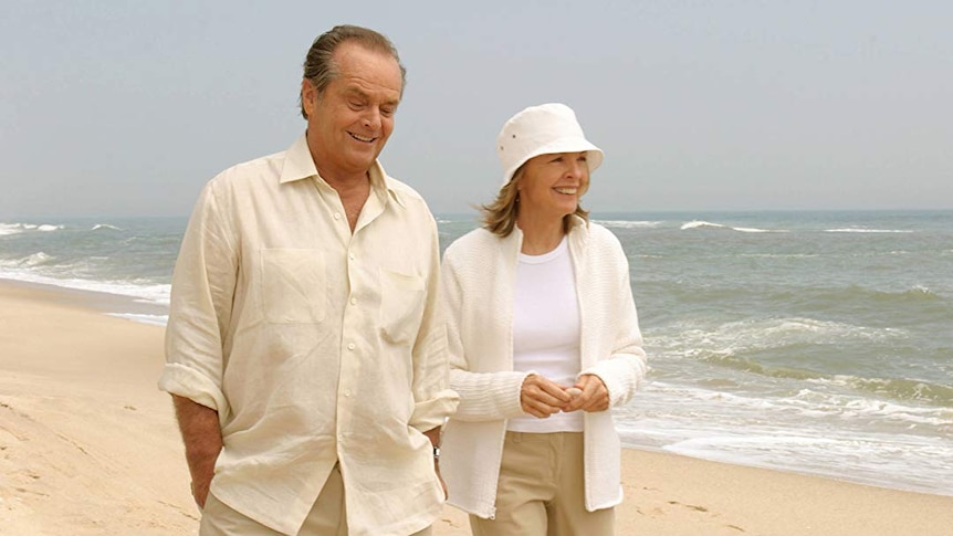 Jack Nicholson and Diane Keaton walk along a beach, dressed all in white, in scene from Something's Gotta Give.