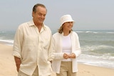 Jack Nicholson and Diane Keaton walk along a beach, dressed all in white, in scene from Something's Gotta Give.
