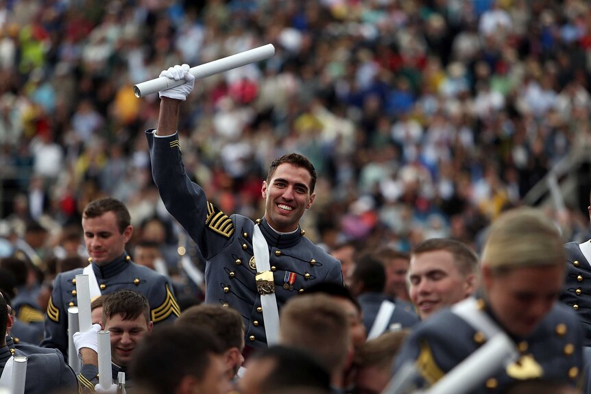 Graduates celebrate at a commencement ceremony at West Point Military Academy.