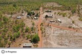 Overhead shot of remote houses on red dirt