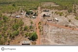 Overhead shot of remote houses on red dirt