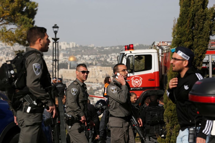 Israeli security forces work at the scene of a truck ramming incident in Jerusalem