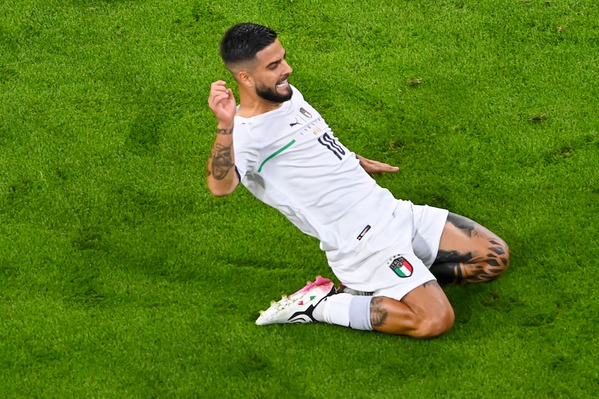 Lorenzo Insigne slides on his knees and smiles