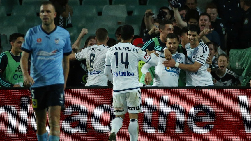 Melbourne Victory's Kosta Barbarouses (2ndR) celebrates after scoring against Sydney FC at the SFS.