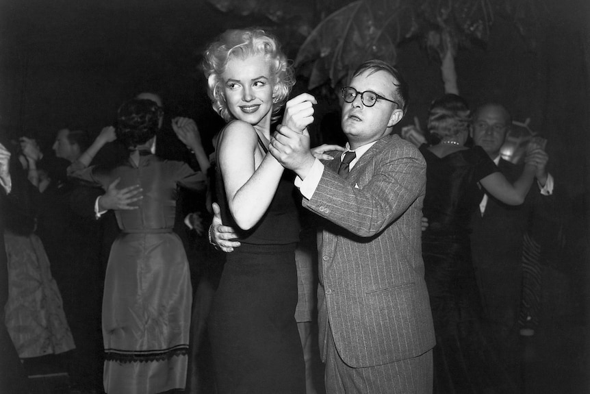 Black and white photo of Marilyn Monroe and Truman Capote dancing 