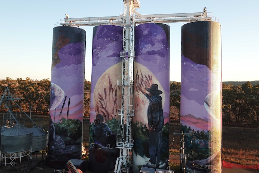 four grain silos painted in colours