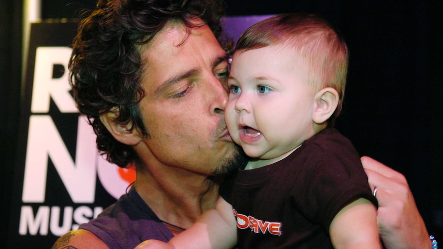 Chris Cornell gives his baby daughter Toni a kiss