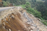 Part of a road on the side of a hill collapsed.