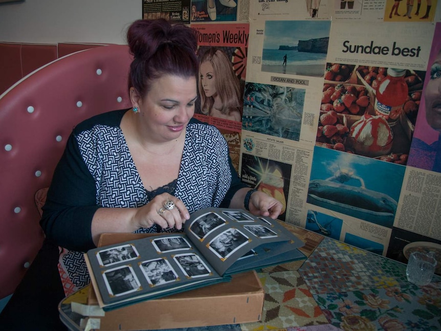 Sofia Fiusco looks through albums belonging to her aunt, Annie Woods