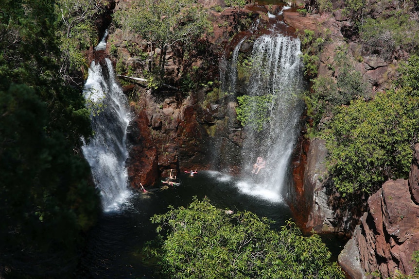 A photo from above of two waterfalls with flowing water.