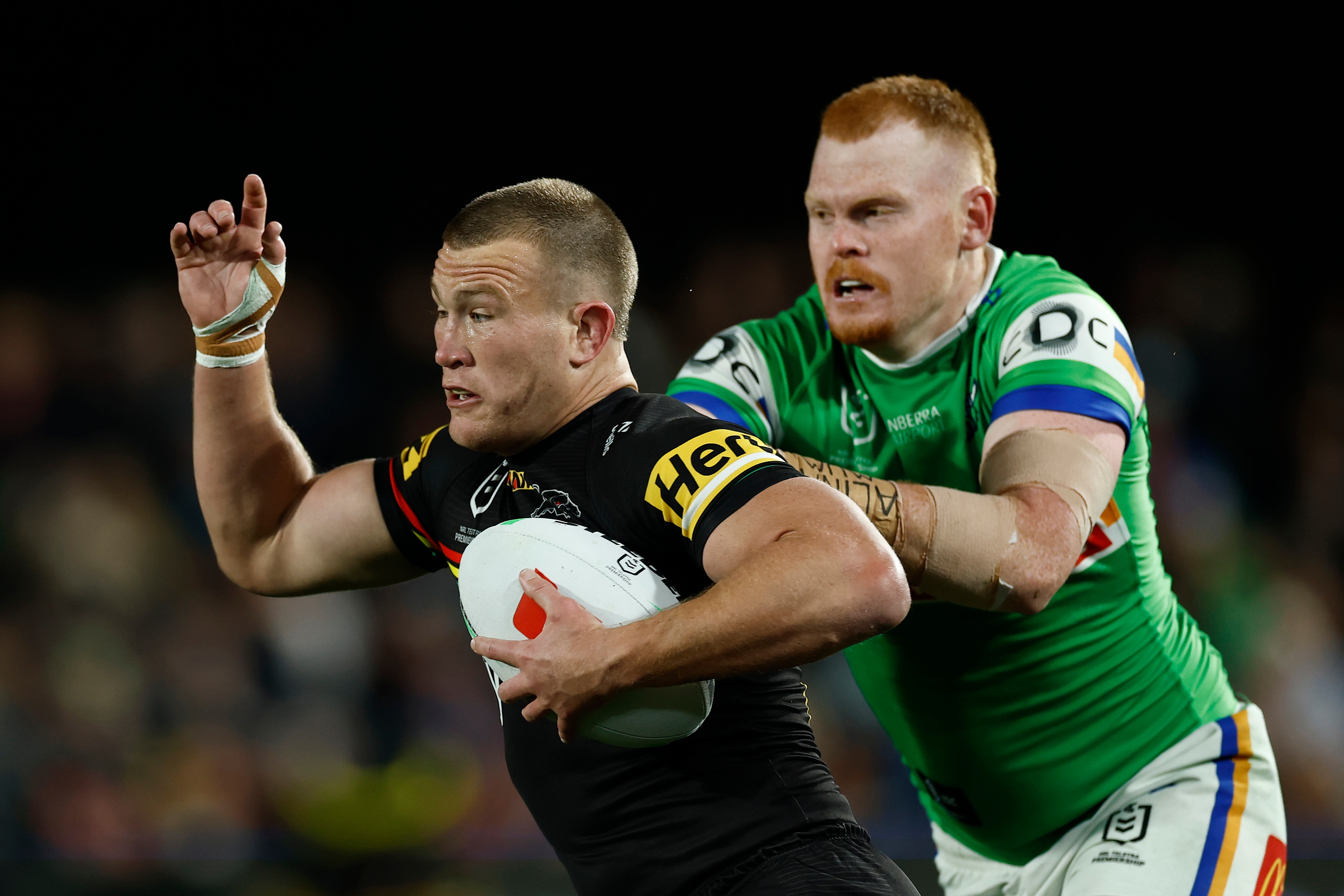 Mitch Kenny of the Panthers is tackled by Corey Horsburgh of the Raiders