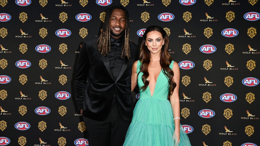 West Coast's Nic Naitanui in a dark suit and his partner Brittany Bown in a flowing green dress at the Brownlow Medal in Perth.