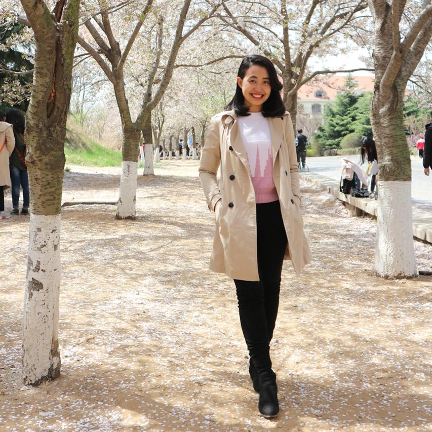 A woman standing with trees