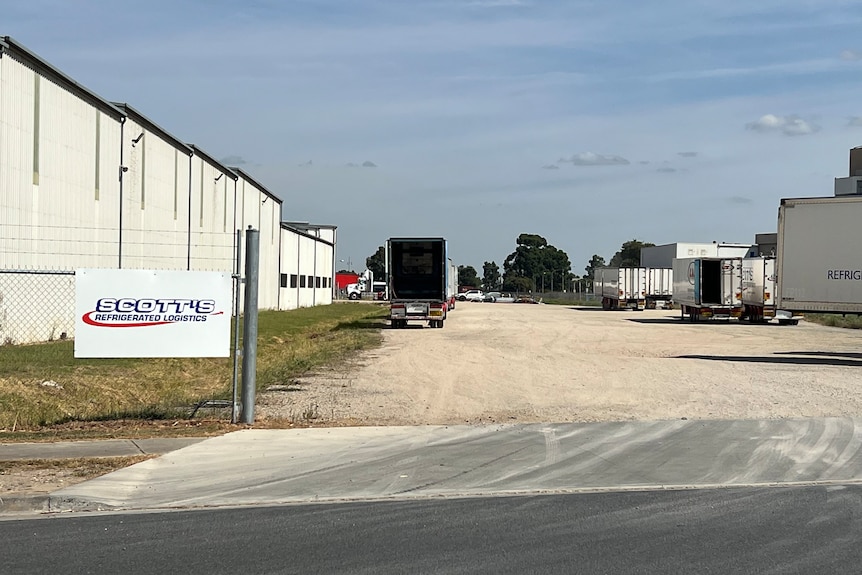 An empty truck in an empty yard.