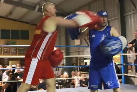 A politician lands a punch on his rival in a charity boxing match.