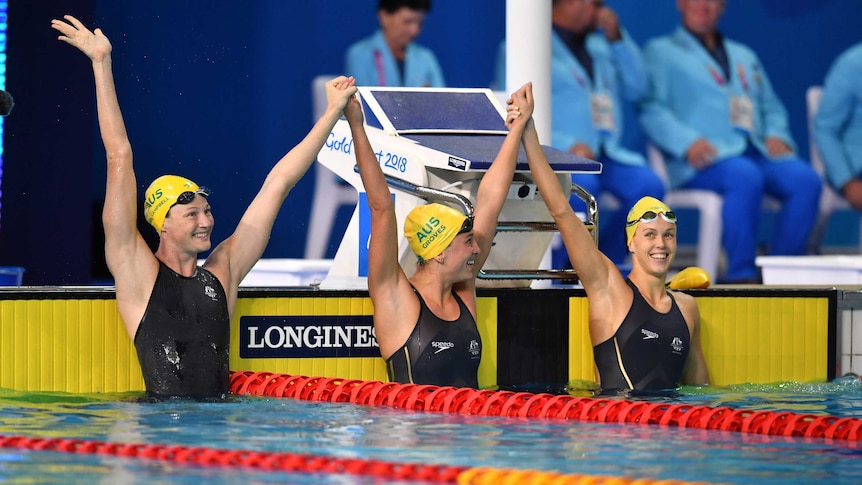 Cate Campbell of Australia celebrates with team mates Holly Barratt and Madeline Groves.