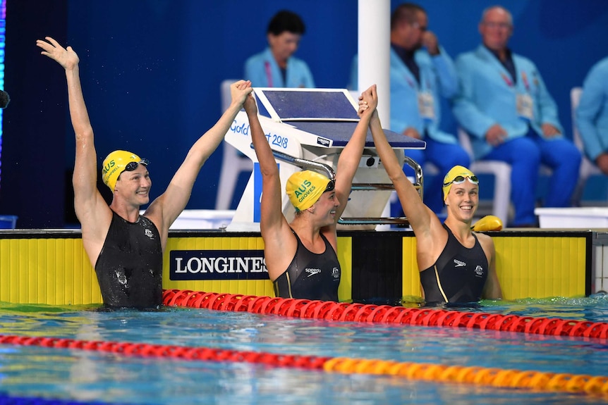 Cate Campbell of Australia celebrates with team mates Holly Barratt and Madeline Groves.