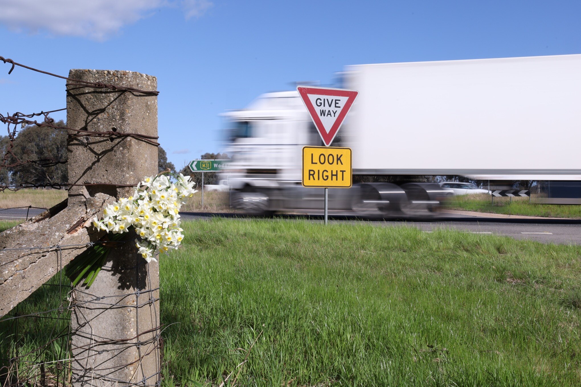 Flowers placed near the scene of a fatal crash on the Hume Freeway near Chiltern