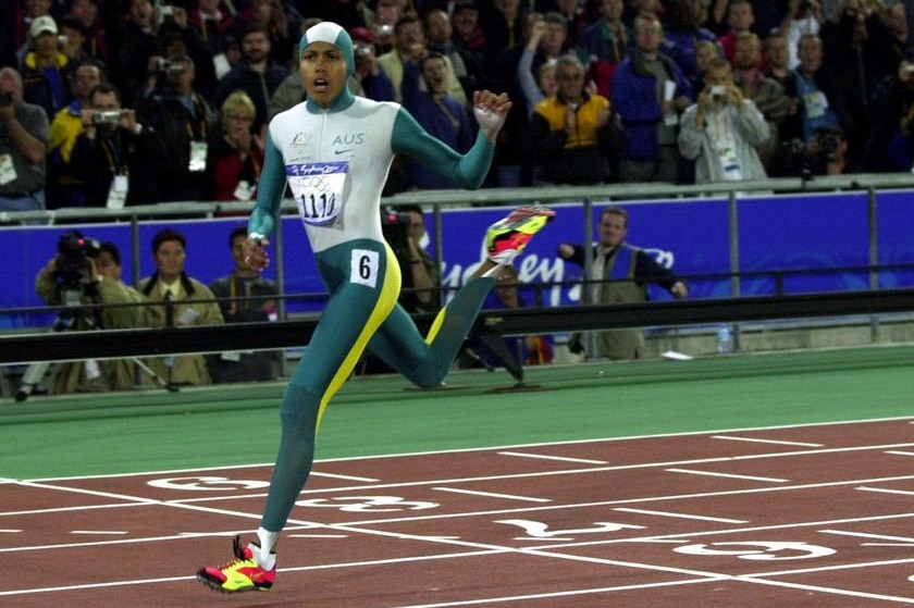 Cathy Freeman, wearing a full bodysuit, crosses the line to win the women's 400m at the Sydney Olympics.