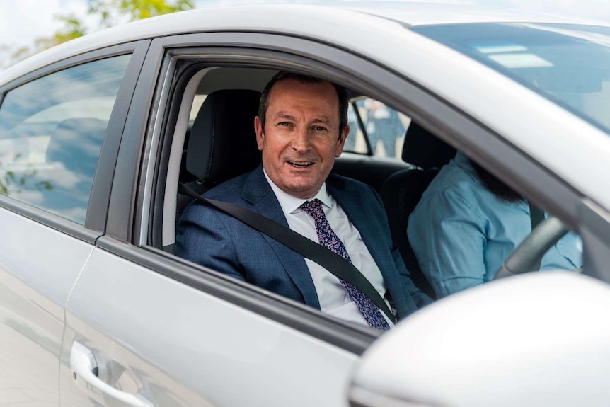 Mark McGowan sitting in an electric vehicle.