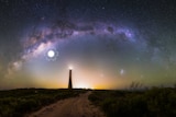 The arch of the Milky Way over the Guilderton Lighthouse in Western Australia, and the Large and Small Magellanic Clouds.