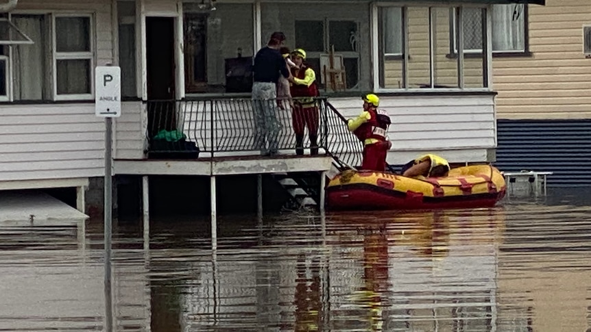 Queensland Fire Emergency and Rescue swiftwater in dinghy crew evacuates resident from Warwick home, floodwater under hom