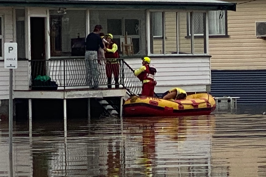 Queensland Fire Emergency and Rescue swiftwater in dinghy crew evacuates resident from Warwick home, floodwater under hom
