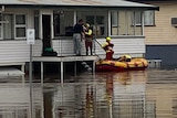 Queensland Fire Emergency and Rescue swiftwater in dinghy crew evacuates resident from Warwick home, floodwater under hom