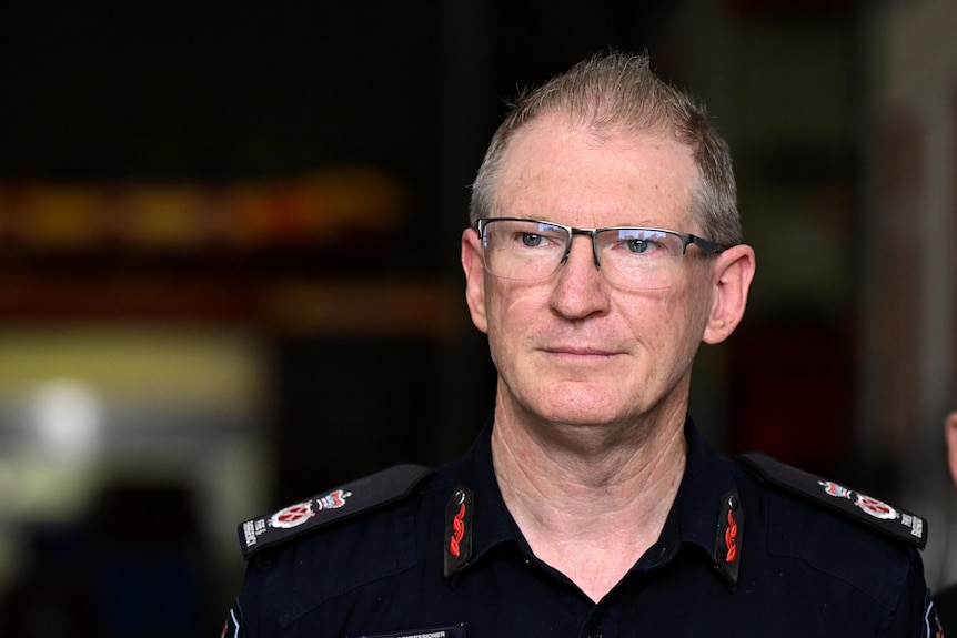 a head-and-shoulders close-up of the qfes commissioner during a press conference