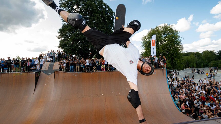 Young man doing a stunt on a skateboard