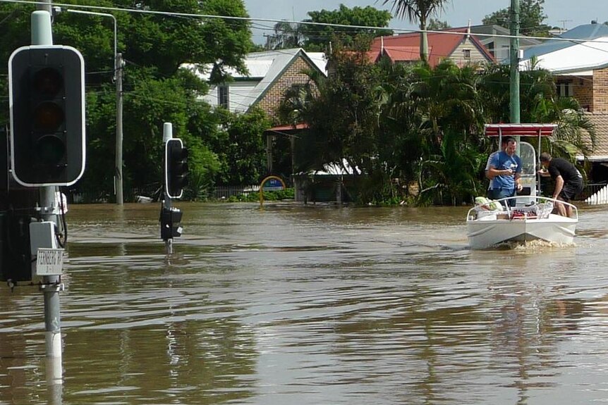 People on a boat survey flooded Baroona Road at Milton in Brisbane on January 13, 2011.