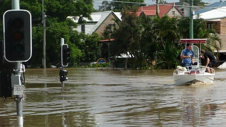 People on a boat survey flooded Baroona Road at Milton in Brisbane on January 13, 2011.