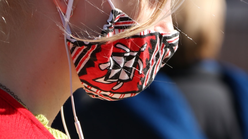 A young woman in a face mask