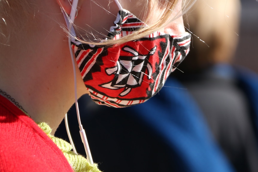 A young woman in a face mask