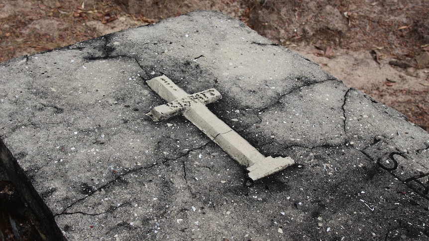 A cross on an above-ground grave.