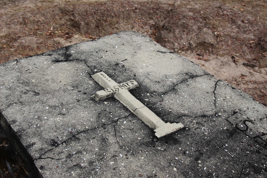 A cross on an above-ground grave.