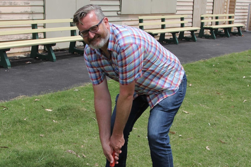 Justin Mansfield prepares to hit a ring in a game of Trugo at Footscray Trugo Club.