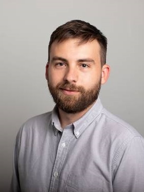 A bearded man in a shirt. 